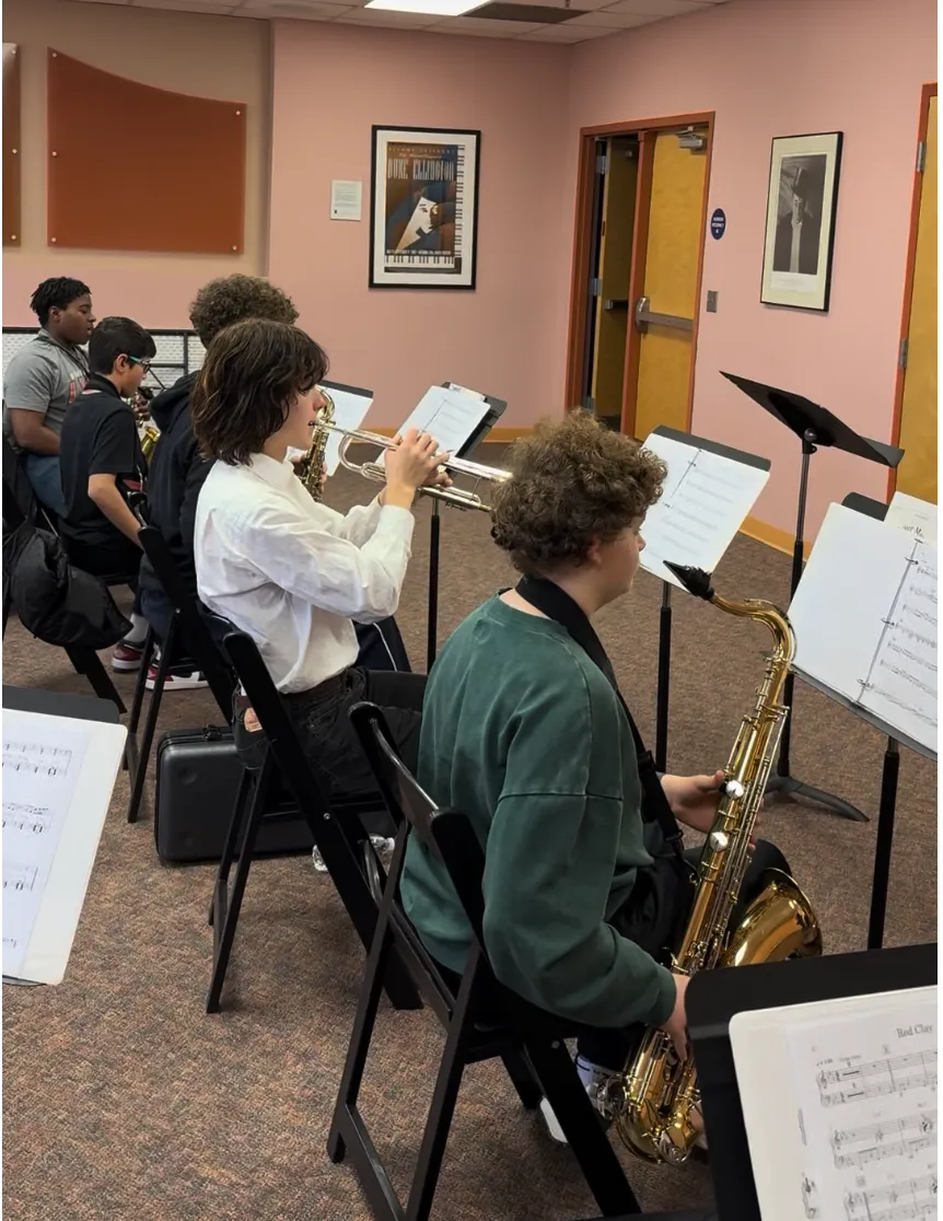 Students rehearse in the 12th Street Combo, a young saxophonist playing from a music stand.